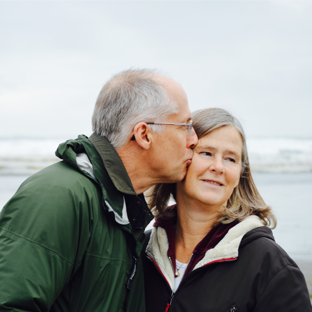 Retired couple, man kissing woman on cheak